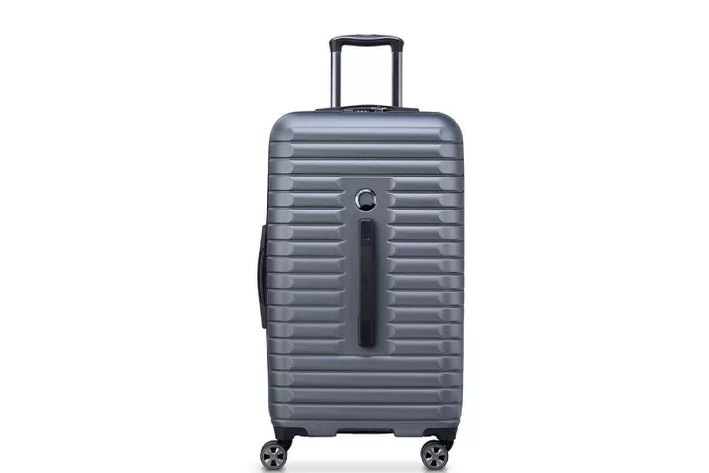 Travelpro Platinum Elite handle fully extended next to a tall traveler