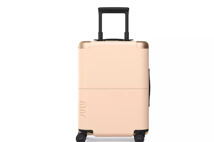 open suitcase showing packed compartments, kids' clothes visible