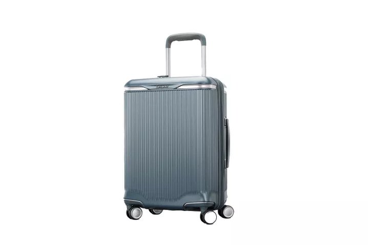 family loading two different suitcase brands into a car trunk