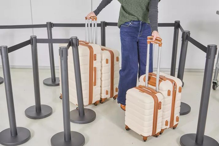 four carry-ons lined up side by side for a wheel comparison shot