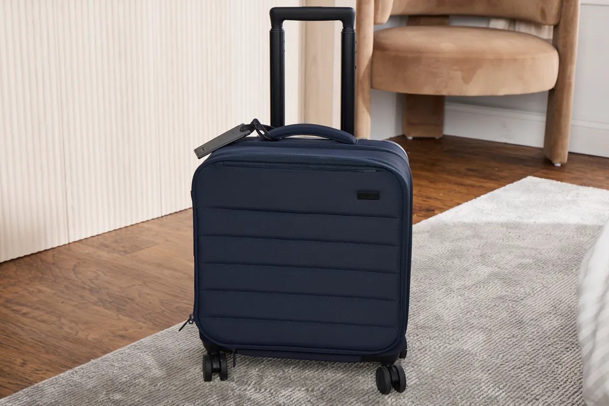 interior of the open suitcase showing mesh divider and packed clothes